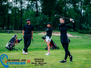 A handsome man and two beautiful women enjoying a round of golf on a slightly overcast, yet wonderful day.