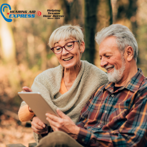 Older couple on a park bench smiling.